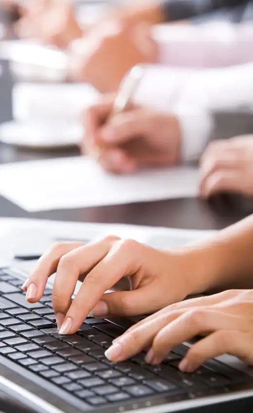 Hands typing on a laptop during a team meeting, representing the collaboration of a team of scientific experts Hands typing on a laptop during a team meeting, representing the collaboration of a team of scientific experts.